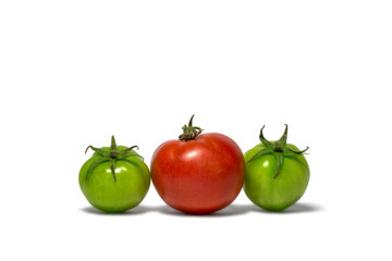 One ripe red tomato and two green on white background