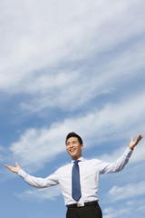 Businessman Standing with Arms Outstretched