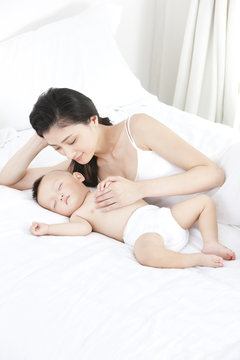 Gentle mother with sleeping baby