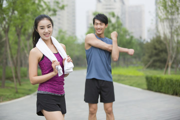 Young couple doing exercise outside