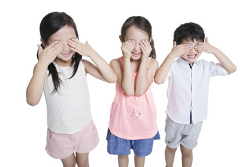 Happy children covering eyes with hands