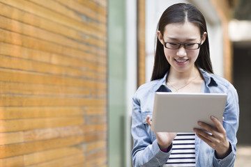 Young woman using digital tablet