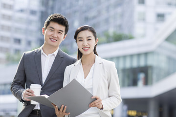 Young business person working with coffee outdoors