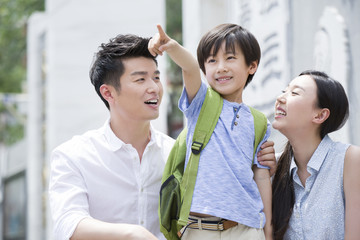 Fototapeta premium Happy schoolboy with his parents