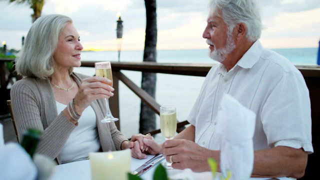 Caucasian seniors enjoying romantic dining on vacation