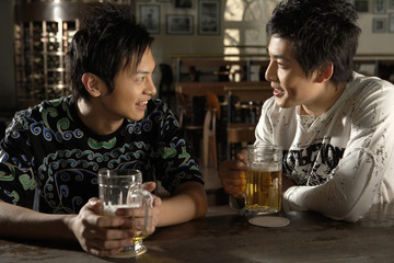 Men Drinking Beer In A Bar