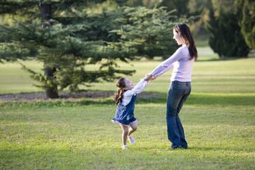 Fototapeta premium Mother and daughter playing in the park