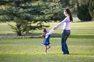Mother and daughter playing in the park