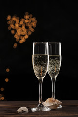 Champagne and heart-shaped glittering light