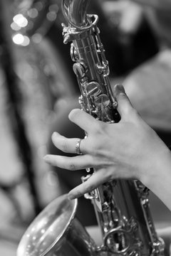  Hand girl playing the saxophone in black and white 