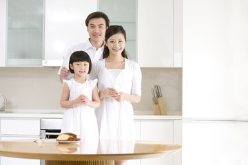 Portrait of a young family in the kitchen