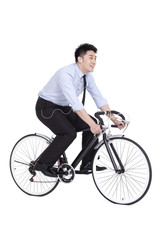 Fototapeta na wymiar Cheerful young businessman riding a bike