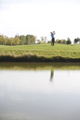 Fototapeta premium Man swinging golf club on golf course