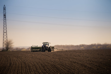 Fototapeta premium panorama of operating tractor in field