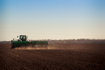Fototapeta premium panorama of tractor sowing in field