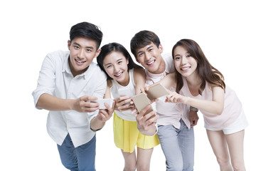 Fototapeta premium Young adults using smart phones