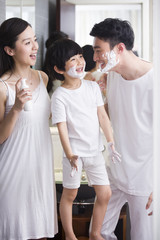Family in bathroom with shaving cream on chin