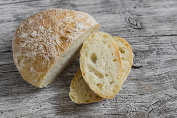 Homemade rustic bread on light wooden board