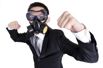 Young businessman with gas mask in fighting position