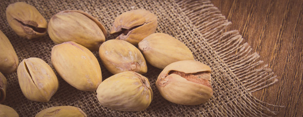 Vintage photo, Pistachio nuts on wooden table, healthy eating