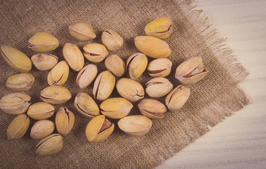 Vintage photo, Pistachio nuts on white wooden table, healthy eating