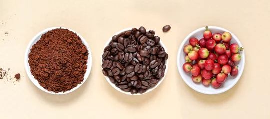 Fotobehang Red coffee beans berries, roasted coffee and coffee powder on beige paper background. © virojp