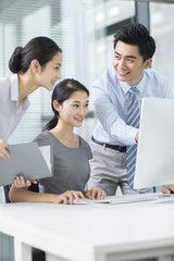 Young business people using computer in office