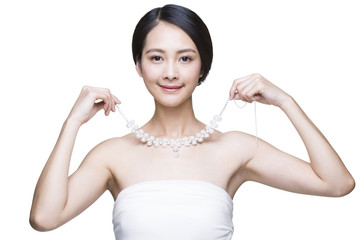 Beautiful young woman with diamond necklace