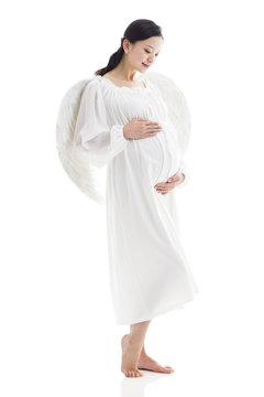 Pregnant woman wearing angel wings