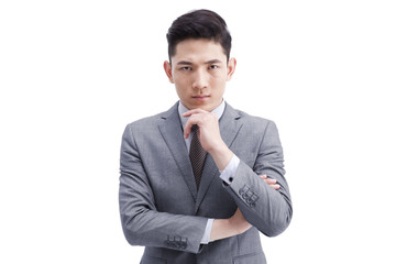 Confident young businessman hand on chin