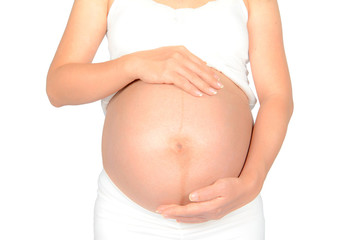 Close up of a cute pregnant belly on white background
