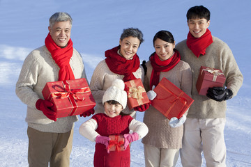 Happy family holding gift boxes