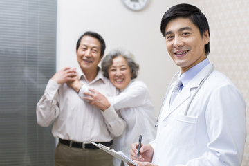 Doctor with senior couple in hospital