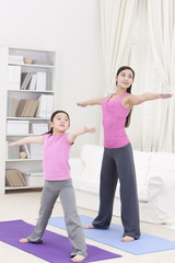 Fototapeta na wymiar Monther and daughter doing yoga