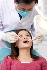 Naklejka premium Patient receiving treatment in dental clinic