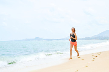 Fototapeta na wymiar Sports. Fit Female Athlete Jogger Running On Beach. Sporty Athletic Woman Jogging During Workout Outside. Fitness, Exercising, Healthy Lifestyle. Health Concept
