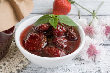 Canned strawberry confiture and jam sandwich on the wooden board