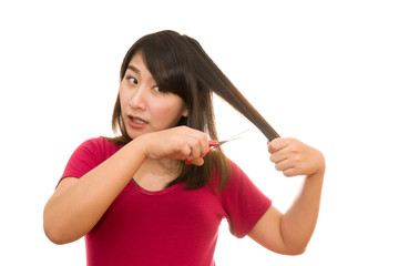 woman cutting her hair with scissors - unhappy expression, isola