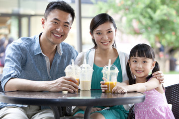 Family enjoying cold drink together