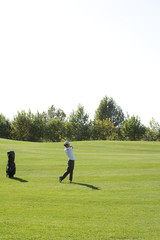 Young Man Taking a Golf Swing