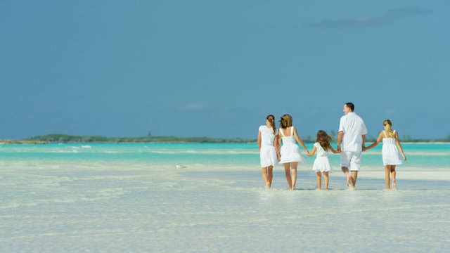 Happy Caucasian family enjoying a beach vacation 