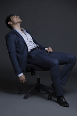 Tired businessman in chair