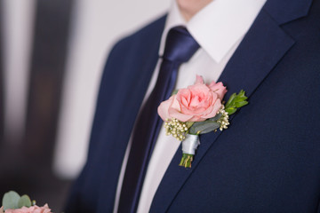 Boutonniere on trendy groom at wedding