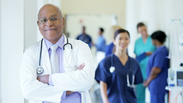 Portrait of confident African American male senior doctor in medical centre