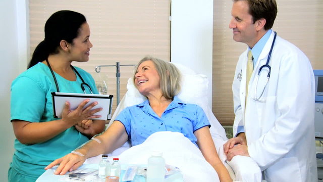 Hispanic nurse Caucasian male female hospital patient doctor touch screen tablet