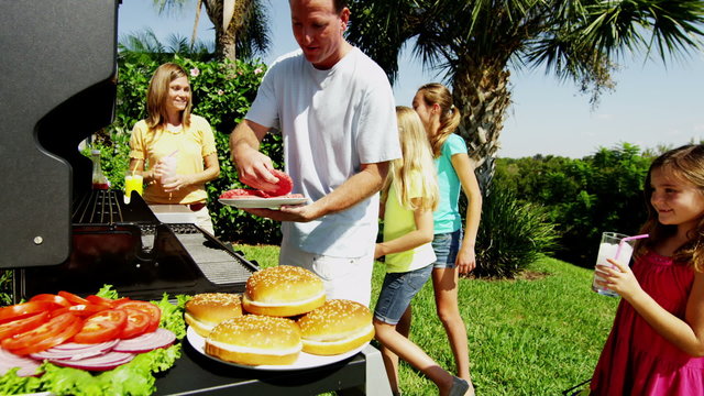 Caucasian Parents Young Female Children Cooking Casual Outdoor Garden Barbecue