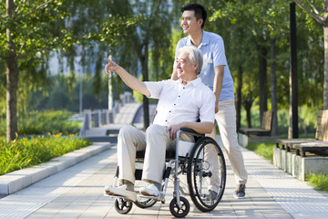 Wheelchair bound man with nursing assistant