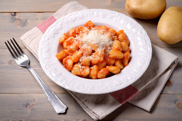 Homemade potato gnocchi with tomato sauce and parmigiano