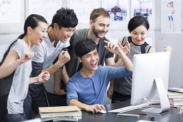 Young adults celebrating in office