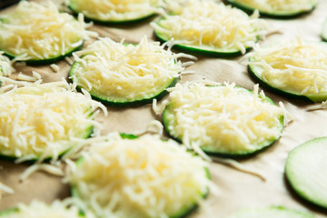 Zucchini slices with grated cheese ready to bake